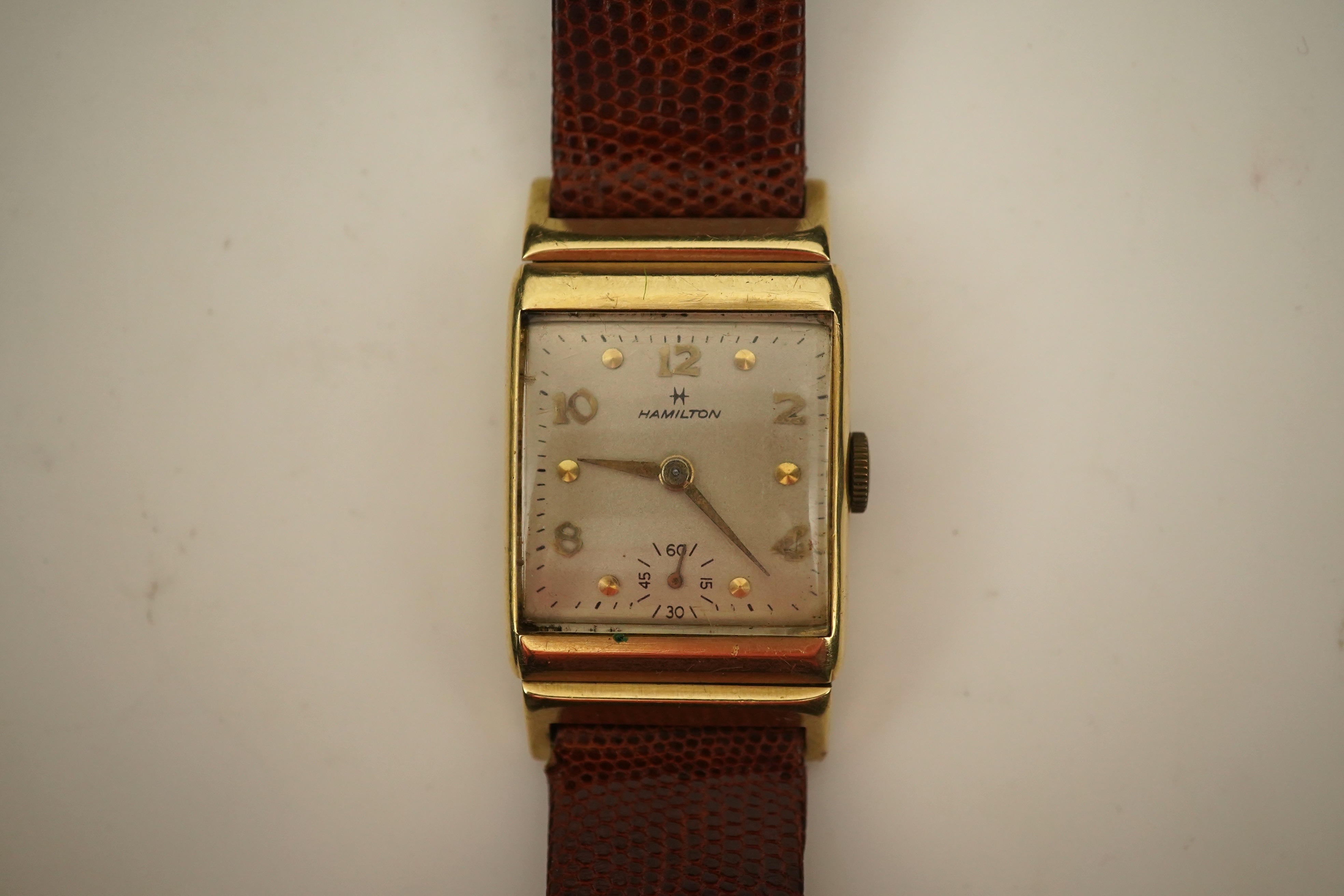 A gentleman's 1950's? 14k gold Hamilton manual wind wrist watch, on a later associated leather strap